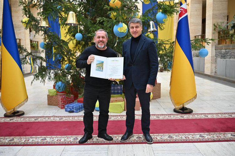 Мирослав Білецький вручає відзнаку волонтеру